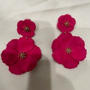 Pinkish red statement earrings.